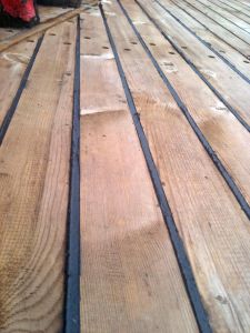 caulking a wooden deck and sealing deck seams on a wooden boat