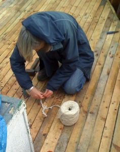 Cotton caulking wooden deck seam repairs on converted MFV