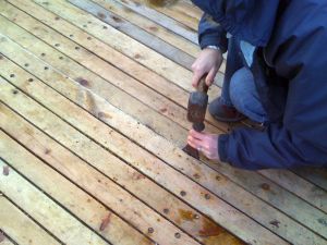 using caulking irons to caulk wooden deck seam repairs on Zulu herring drifter